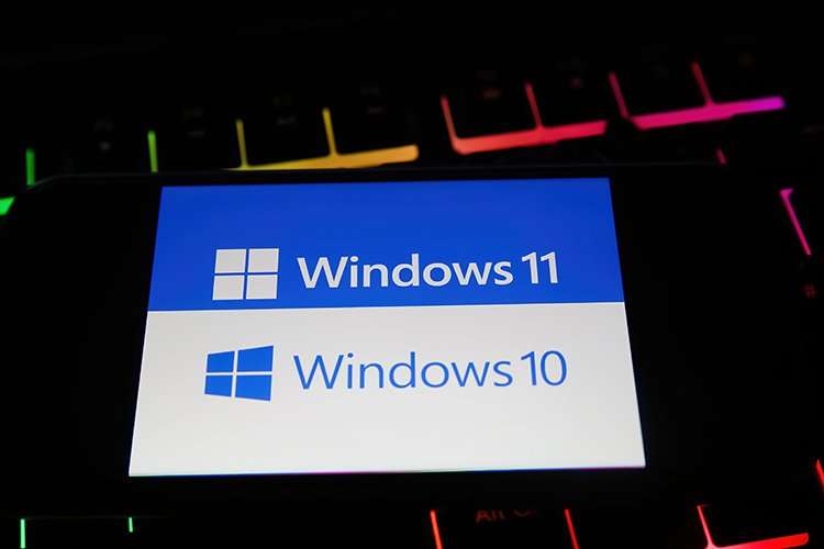 Computer screen displaying Windows 10 logo with a warning sign, indicating end of support